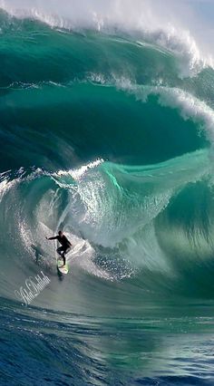 a man riding a wave on top of a surfboard