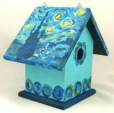 a blue birdhouse with a painting on it's roof that looks like the starry night