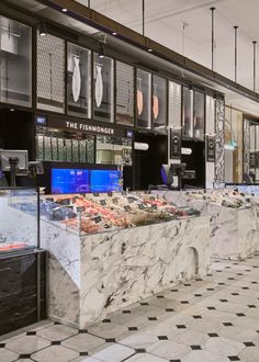 the interior of a restaurant with marble counter tops