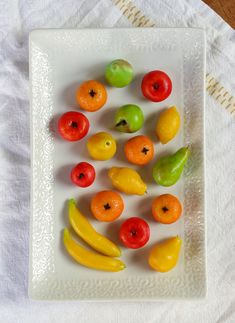 a white plate topped with fruit on top of a table