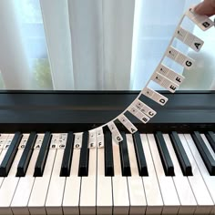 a person is playing on a piano with musical notes attached to the keys and strings