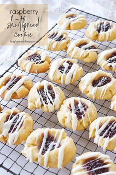 raspberry shortbread crinkle cookies with icing on a cooling rack