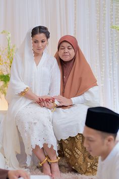 two women in traditional garb sitting next to each other