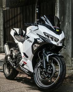 a white and black motorcycle parked on the street