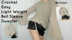 an image of a woman wearing a sweater with bell sleeves and high low waist shorts