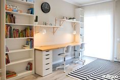 a room with a desk and shelves filled with books