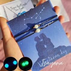 a hand holding a card with two green lights on it and an image of a kissing couple