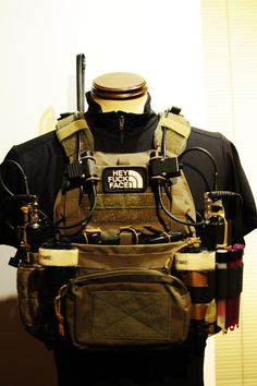 the back of a man's vest with multiple items attached to it