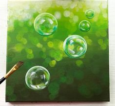 an acrylic painting of soap bubbles on a green background with a paintbrush