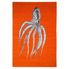 an orange area rug with an octopus on it's back and white tentacles in the middle