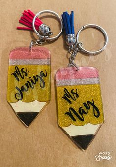 two keychains with the words mrs and mrs on them are sitting next to each other