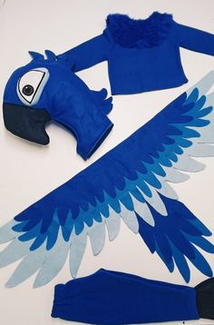 paper cut out of blue and white bird wings, leggings and headdress