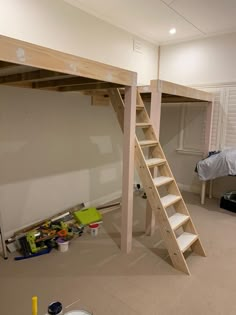 a loft bed with ladders is in the process of being built into an apartment