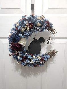 a blue and red wreath hanging on the front door