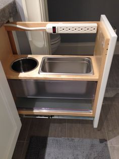 the kitchen sink is built into the cabinet in the small space that's attached to the wall