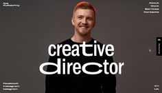 a man with red hair standing in front of a grey background that says creative director