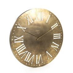 a gold clock with roman numerals is shown against a white background for display