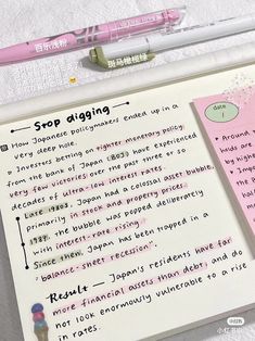 a notepad with writing on it next to a pen and eraser set up