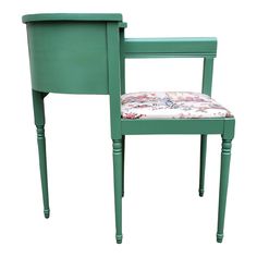 a green chair with a floral upholstered seat