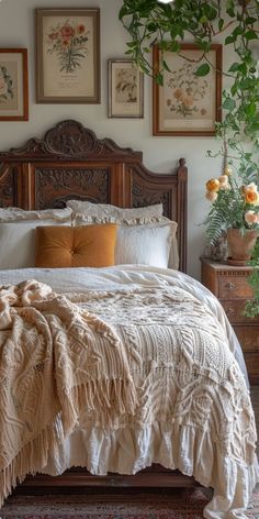 a large bed sitting in a bedroom next to two planters on either side of the bed