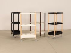 three shelving units with black and white shelves