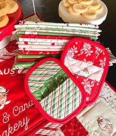 several red and green christmas themed place mats on a table with cookies in the background