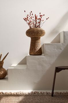 two baskets with flowers are sitting on the stairs