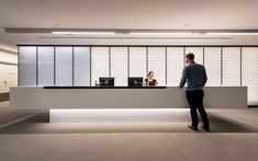 a man standing in front of a reception counter