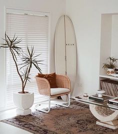 a living room filled with furniture and a surfboard