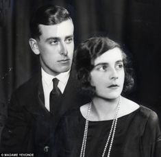 an old black and white photo of a man and woman with pearls on their necklaces