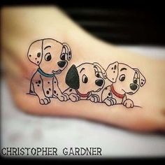 a small tattoo of three dogs on the foot