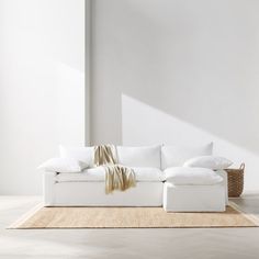 a white couch sitting on top of a rug