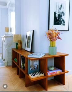 a wooden table topped with books and flowers