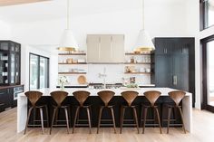 a kitchen filled with lots of counter top space next to a dining room table and chairs