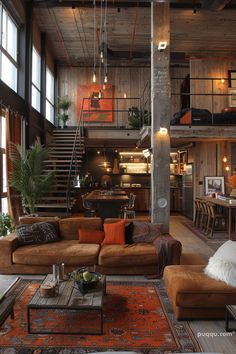 a living room filled with furniture and lots of windows next to a stair case on the wall