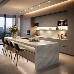 a modern kitchen with marble counter tops and chairs