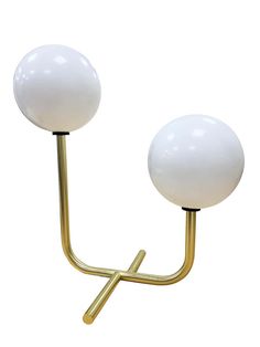 a pair of white glass and gold metal lamps