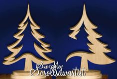 two wooden christmas trees sitting on top of a table next to a blue background with the words, she got sewedlwald