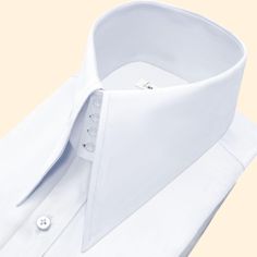 High Long Pointed Collar Tailor-Made On Order shirt 𝘈 𝘸𝘩𝘪𝘵𝘦 𝘩𝘪𝘨𝘩-𝘤𝘰𝘭𝘭𝘢𝘳 𝘴𝘩𝘪𝘳𝘵 𝘪𝘴 𝘢 𝘤𝘭𝘢𝘴𝘴𝘪𝘤 𝘢𝘯𝘥 𝘵𝘪𝘮𝘦𝘭𝘦𝘴𝘴 𝘸𝘢𝘳𝘥𝘳𝘰𝘣𝘦 𝘴𝘵𝘢𝘱𝘭𝘦 𝘵𝘩𝘢𝘵 𝘦𝘹𝘶𝘥𝘦𝘴 𝘴𝘰𝘱𝘩𝘪𝘴𝘵𝘪𝘤𝘢𝘵𝘪𝘰𝘯 𝘢𝘯𝘥 𝘦𝘭𝘦𝘨𝘢𝘯𝘤𝘦. 𝘛𝘩𝘪𝘴 𝘵𝘺𝘱𝘦 𝘰𝘧 𝘴𝘩𝘪𝘳𝘵 𝘧𝘦𝘢𝘵𝘶𝘳𝘦𝘴 𝘢 𝘤𝘰𝘭𝘭𝘢𝘳 𝘵𝘩𝘢𝘵 𝘴𝘵𝘢𝘯𝘥𝘴 𝘶𝘱 𝘢𝘯𝘥 𝘦𝘯𝘤𝘪𝘳𝘤𝘭𝘦𝘴 𝘵𝘩𝘦 𝘯𝘦𝘤𝘬, 𝘱𝘳𝘰𝘷𝘪𝘥𝘪𝘯𝘨 𝘢 𝘳𝘦𝘧𝘪𝘯𝘦𝘥 𝘢𝘯𝘥 𝘱𝘰𝘭𝘪𝘴𝘩𝘦𝘥 𝘭𝘰𝘰𝘬. 𝘛𝘩𝘦 𝘤𝘳𝘪𝘴𝘱 𝘸𝘩𝘪𝘵𝘦 𝘤𝘰𝘭𝘰𝘳 𝘰𝘧 𝘵𝘩𝘦 𝘴𝘩𝘪𝘳𝘵 𝘪𝘴 𝘷𝘦𝘳𝘴𝘢𝘵𝘪𝘭𝘦 𝘢𝘯𝘥 𝘱𝘢𝘪𝘳𝘴 𝘸𝘦𝘭𝘭 𝘸𝘪𝘵𝘩 𝘢 𝘷𝘢𝘳𝘪𝘦𝘵𝘺 𝘰𝘧 𝘴𝘵𝘺𝘭𝘦𝘴 𝘢𝘯𝘥 𝘤𝘰𝘭𝘰𝘳𝘴, 𝘮𝘢𝘬𝘪𝘯𝘨 𝘪𝘵 𝘢𝘯 𝘪𝘥𝘦𝘢𝘭 𝘤𝘩𝘰𝘪𝘤𝘦 𝘧𝘰𝘳 𝘣𝘰𝘵𝘩 𝘧𝘰𝘳𝘮𝘢𝘭 𝘢𝘯𝘥 𝘤𝘢𝘴𝘶𝘢𝘭 𝘰𝘤𝘤𝘢𝘴𝘪𝘰𝘯𝘴. 𝘛𝘩𝘦 𝘴𝘩𝘪𝘳𝘵 𝘪𝘴 𝘵𝘺𝘱𝘪𝘤𝘢𝘭𝘭𝘺 𝘮 Luxury Business Tops With Collar, Luxury White Shirt With Fold Down Collar, Classic White Fitted Collars, White Collared Business Top, Luxury Business Tops With Fold Down Collar, Luxury Business Top With Fold Down Collar, Luxury White Shirt With Concealed Placket, Solid Business Tops With Collar, Classic Formal Tops With Fold Down Collar