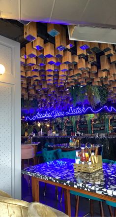 the inside of a restaurant with blue lights and decorations on the walls, along with wooden shelves