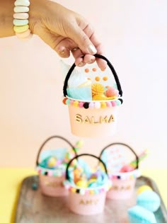 a person is holding a small basket with food inside it on top of a tray