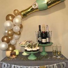 a table topped with champagne bottles and balloons