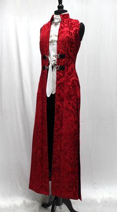 Gorgeous! A dramatic women's cassock coat made in lush red velvet print fabric. Sleeveless with a classic stand-up collar and a slimming fit. Slits in the back sides and front for flowing ease of movement. Fastens in front with two silver metal buckles at mid-section and fully lined with sleek black satin. Comes in sizes Small-3X. Size measurements: Small - Chest 34" Waist 30" Hips 38" Medium - Chest 36" Waist 32" Hips 40" Large - Chest 38" Waist 34" Hips 42" XL - Chest 40" Waist 36" Hips 44" XX Purple Vests, Holiday Clothes, Teased Hair, Fashion Journals, Red And Silver, Vest Coat, Really Cute Outfits, Fantasy Clothing, Fantasy Fashion