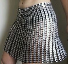 a woman wearing a skirt made out of silver circles on her stomach and the bottom part of her body