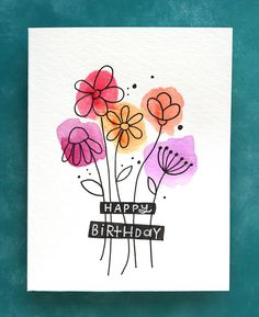 a card with watercolor flowers on it and the words happy birthday written in black ink