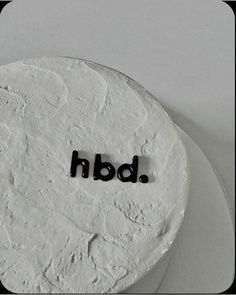 a white cake with the word bdb spelled in black on it's top