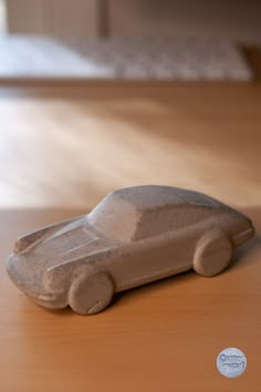 a toy car sitting on top of a wooden table