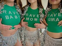 three women in green shirts with silver sequins on their bellys and the words rave, rave, baby, mom written on them