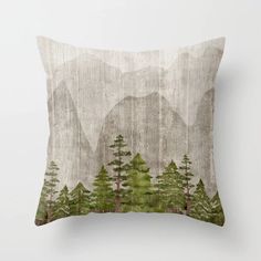 a pillow with trees and mountains on it