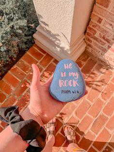 someone is holding up a rock with writing on it that says, no my rock